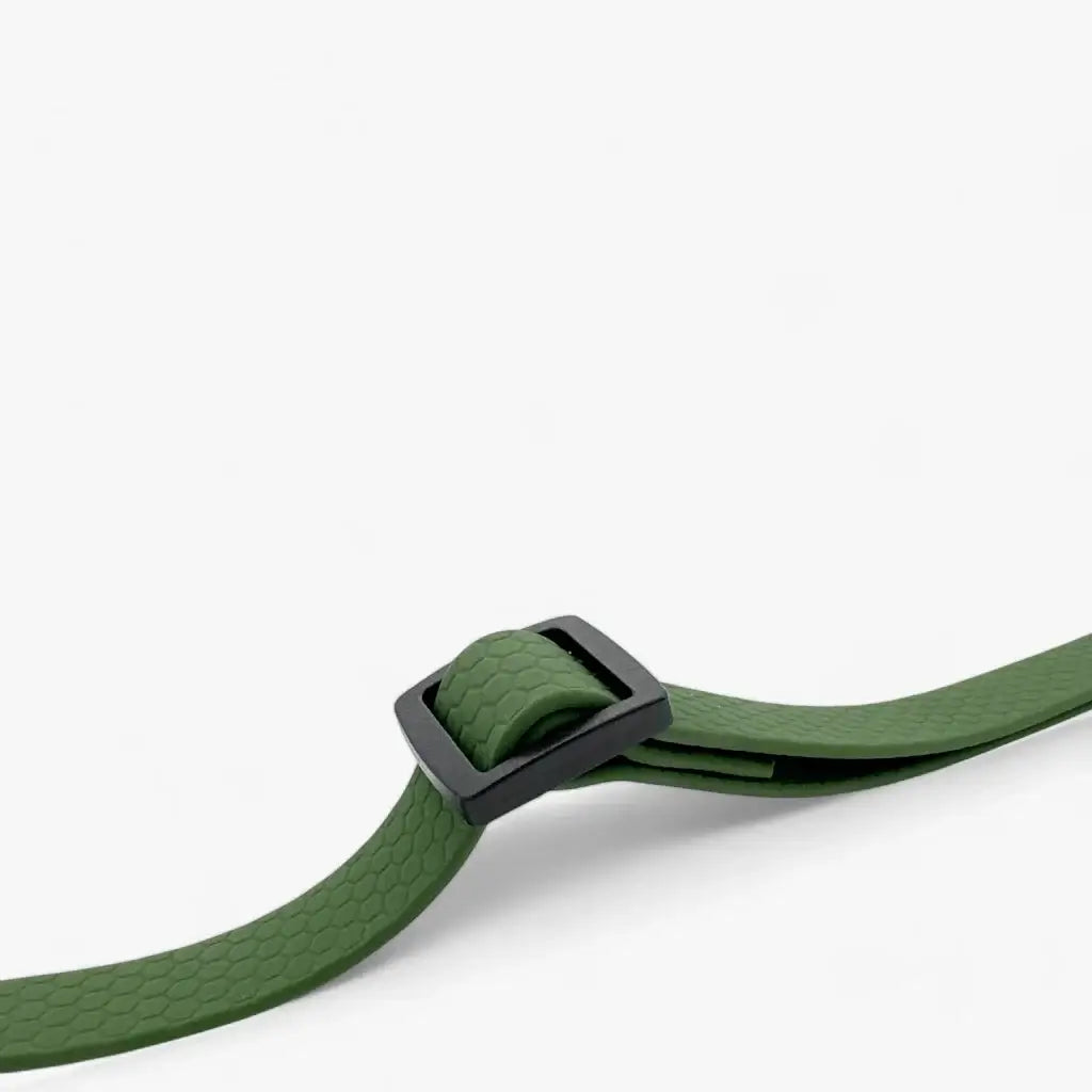 Green dog seatbelt with adjustable buckle, designed for pet safety in vehicles.
